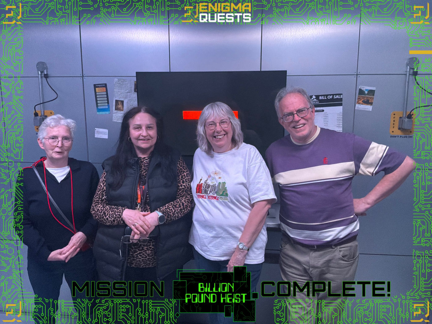 older adults - three women and a man -  celebrating winning an escape room game