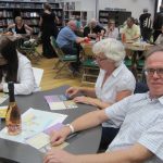 Studying the information at A Taste Of Murder - photo by Juliamaud