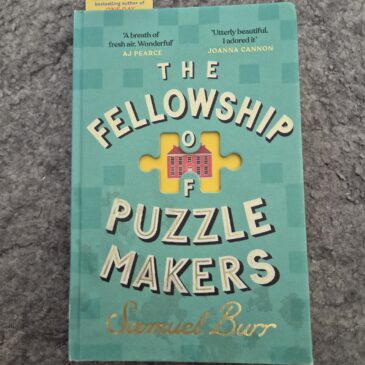 book cover for fellowship of the puzzle makers